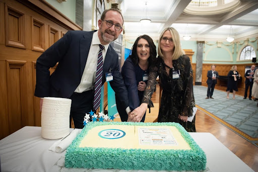 The Minister of Health, Hon Andrew Little, cutting the DHA’s 20th Birthday cake, with Ryl Jensen (DHA CEO) and Kate Reid (DHA Chair).